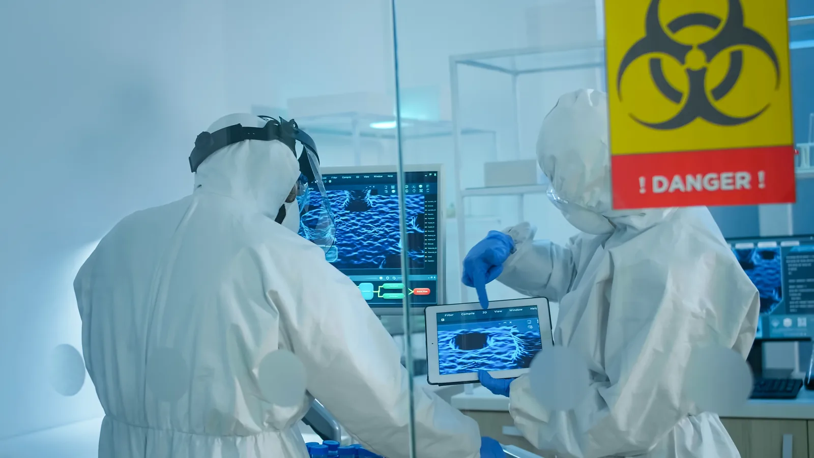 Chemists working in a controlled area of the laboratory